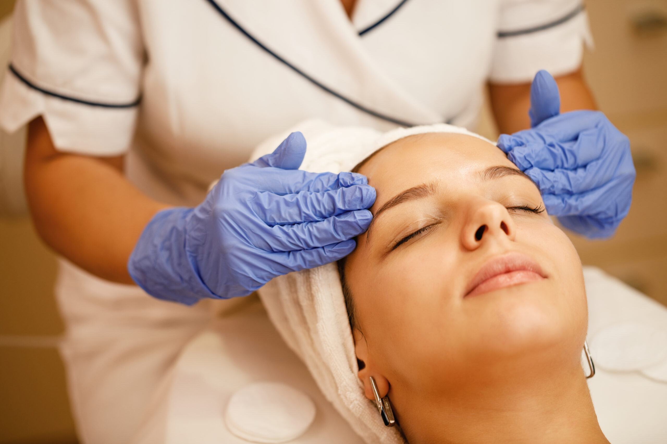 Close-up of woman having facial massage during beauty treatment at the spa.
